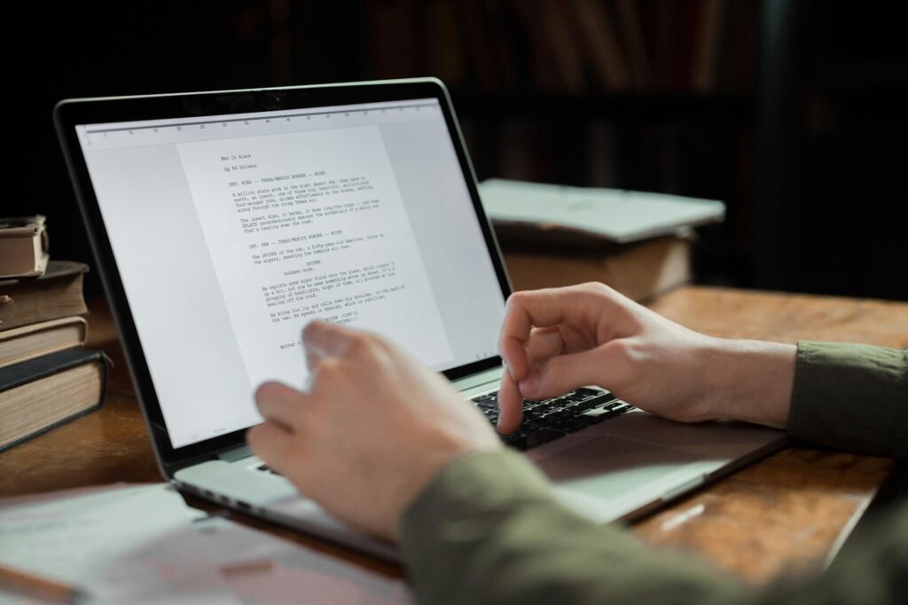 Person writing a eulogy on a laptop in a cozy workspace — best eulogy writing tools for families