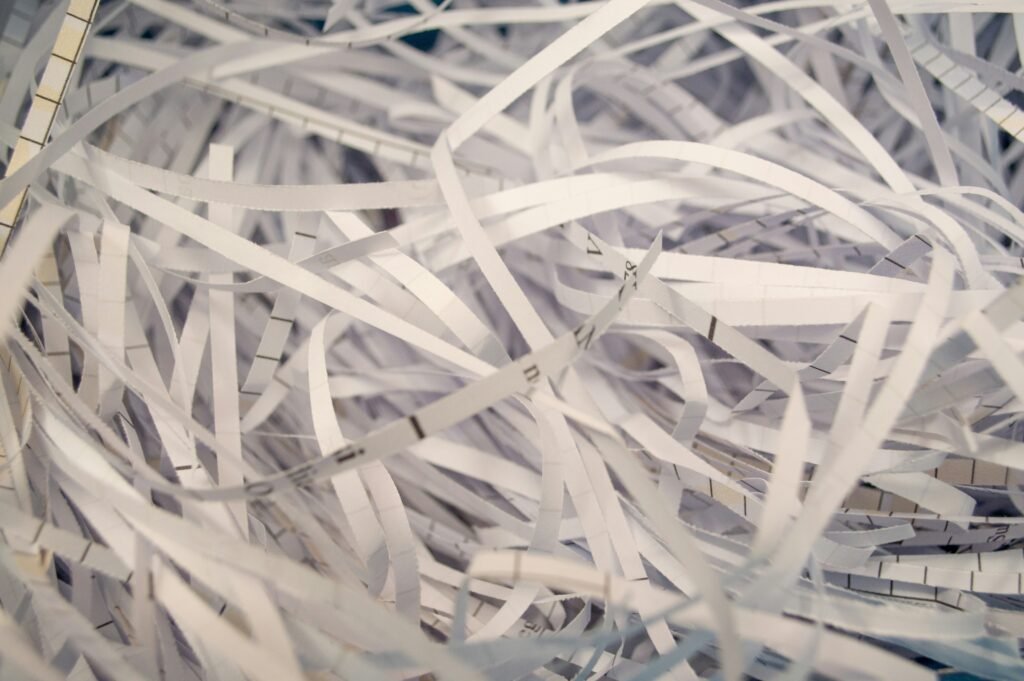Pile of shredded paper documents representing secure document destruction after a loved one passes away