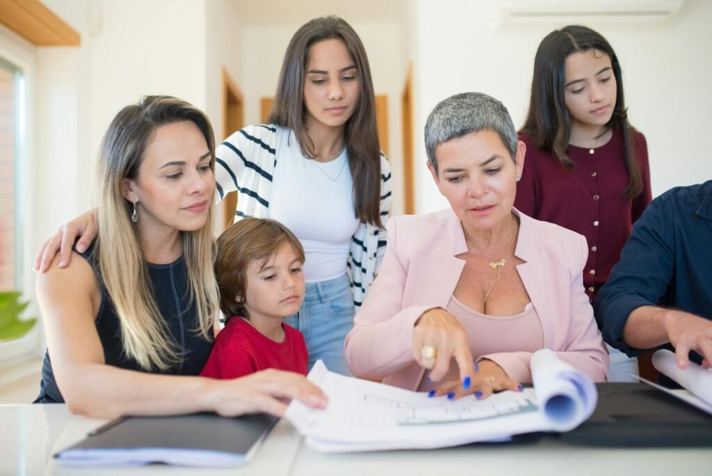 A family group reviewing important documents together at a table, representing secure family document management services with safe access for multiple family members