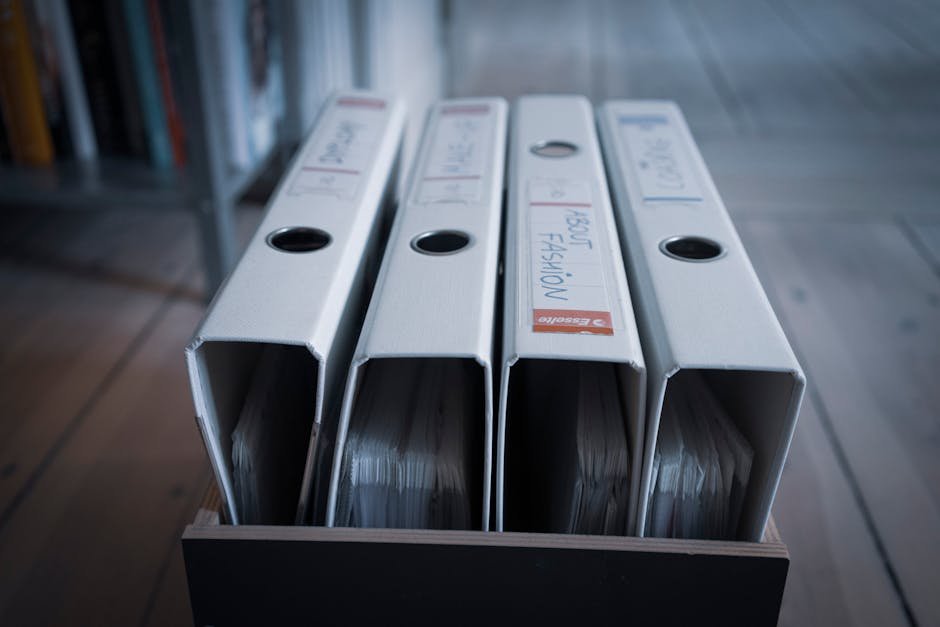 Labeled binders organized on a shelf for family document organization and emergency planning