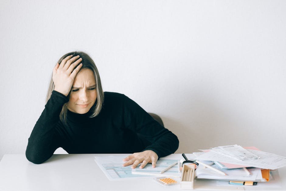 Woman stressed and overwhelmed looking through financial paperwork and documents after a parent's death