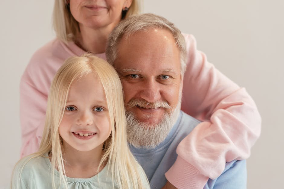 Three generations of a family smiling together — the sandwich generation caring for parents and kids