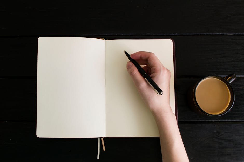 Person writing a to-do list in a notebook with coffee after a funeral, planning next steps