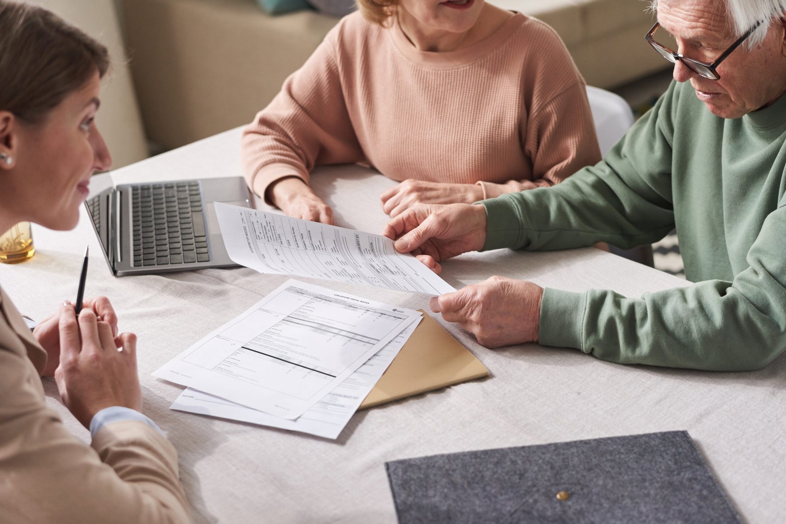 Specialist reviewing paperwork with a couple at their kitchen table